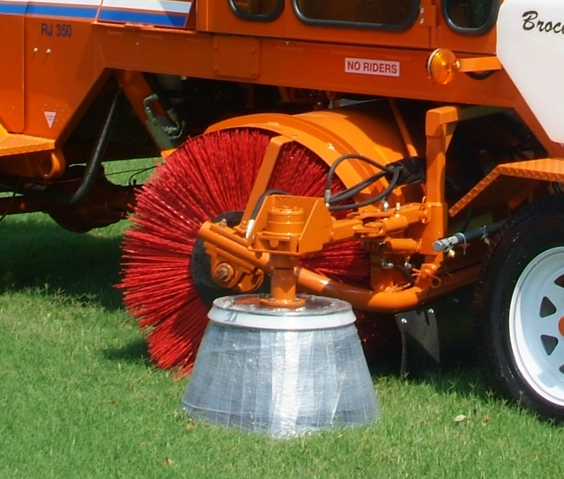 close up view of the Broce Broom curb sweeper